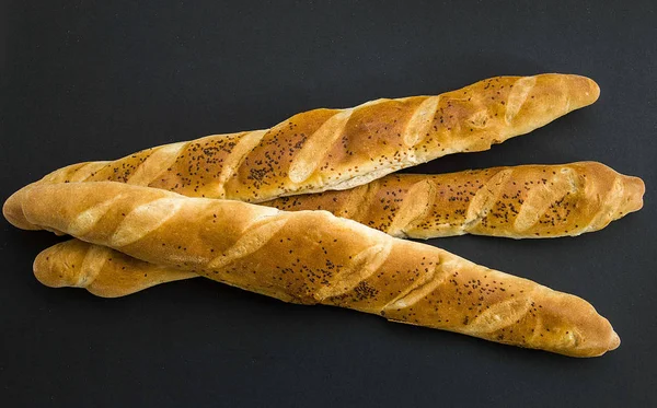 long breads, long thin turkish oven bread with sesame seeds on it,