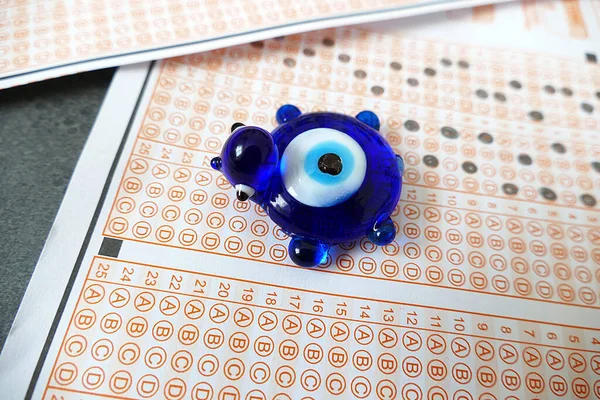 evil eye bead and optical exam paper, exam and luck,