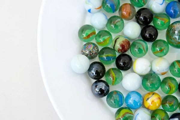 fun game for kids with colored glass marbles, glass balls,