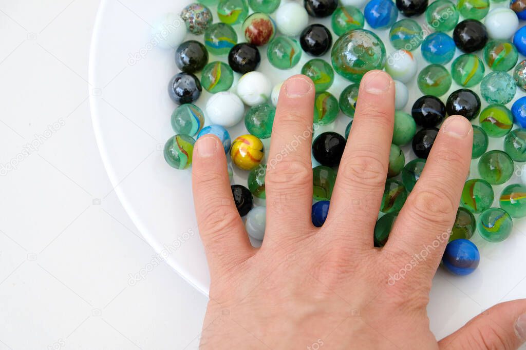 fun game for kids with colored glass marbles, glass balls,