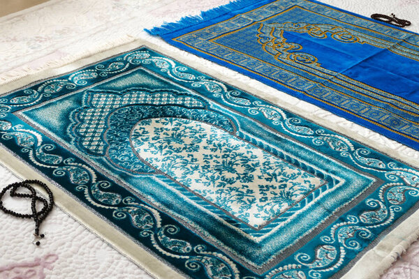 prayer rugs in two different colors prepared for prayer