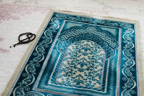 Islamic symbols, prayer rugs on a carpet in a house,