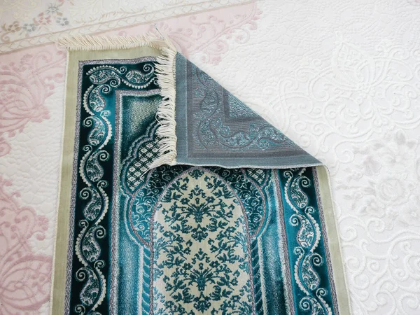 Muslims are praying on prayer rugs, green prayer rug and ramadan month,