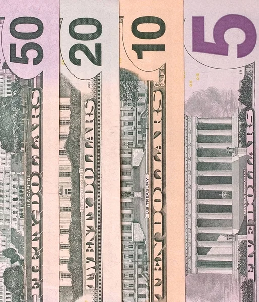 Abstrakta dollarsedlar av olika valörer bakgrund. — Stockfoto