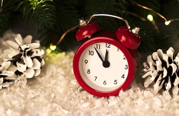 Christmas background with red alarm clock snowflakes cones and cones. — Stock Photo, Image