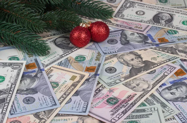 Christmas tree branches red balls on money background. — Stock Photo, Image