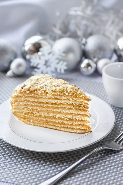 Piece of layer cake with custard and walnuts on a plate — Stock Photo, Image