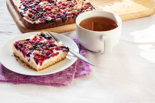 Вкусный завтрак. Вкусный пирог с разнообразными ягодами и творогом и чашкой чая — стоковое фото