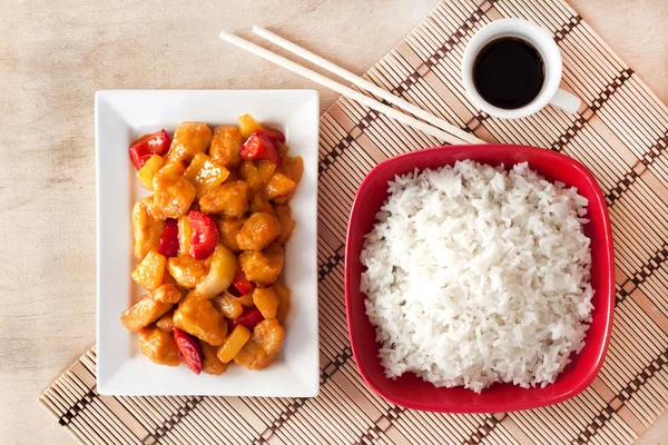 Sweet and sour chicken with bell pepper and pineapple and white rice — Stock Photo, Image