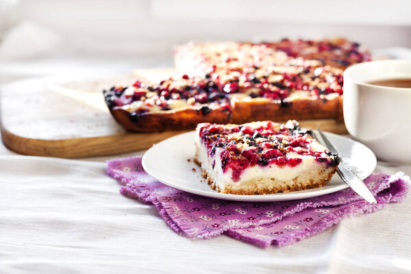 Tasty breakfast. Delicious pie with assorted berries and cottage cheese and a cup of tea