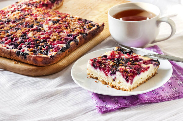 Tasty breakfast. Delicious pie with assorted berries and cottage cheese and a cup of tea