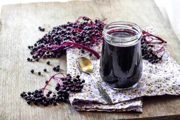 Homemade black elderberry syrup in glass jar — Stock Photo, Image