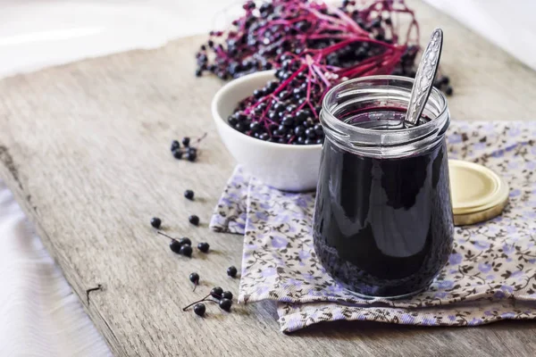 Homemade black elderberry syrup in glass jar — Stock Photo, Image