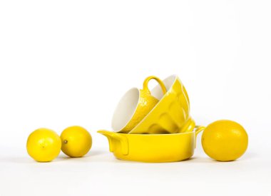  Yellow ceramic crockery tableware with fresh lemons isolated on white background