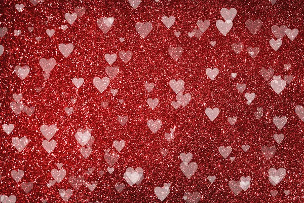 Parlak kırmızı arka plan, parıltı efekti ve kalp şeklinde bokeh — Stok fotoğraf