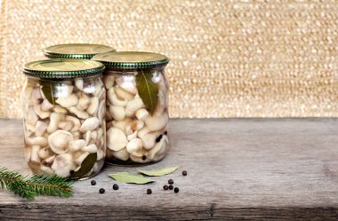 Ev yapımı koruma. Metal kapaklı cam kavanozlarda marine edilmiş Suillus mantarları. Boşluğu kopyala