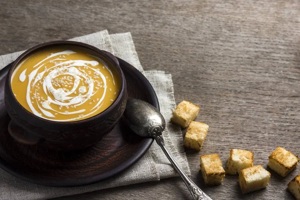 Soupe de citrouille à la crème et graines de sésame avec croûtons sur fond en bois — Photo