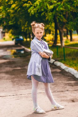 Küçük kız güzel kollarını katlanmış. Moda elbise. Yaz