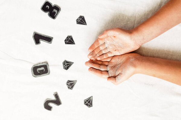 figures and diamonds. children's hands in sparkles. new Year. view from above