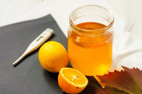 jar of honey. vitamin C. thermometer. health