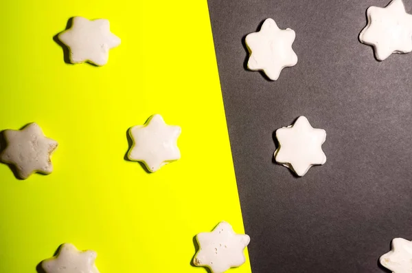 cookies in the form of stars. feast for the feast. background is black and yellow.