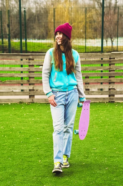 modern girl sport style. in the hands of a penny board