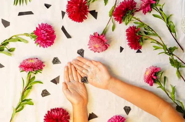 diamonds in the hand. shiny hands. beautiful live flowers