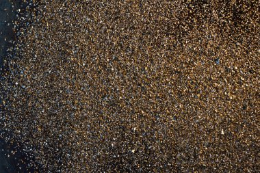 Altın arkaplan - siyah arkaplanda altın tozu.