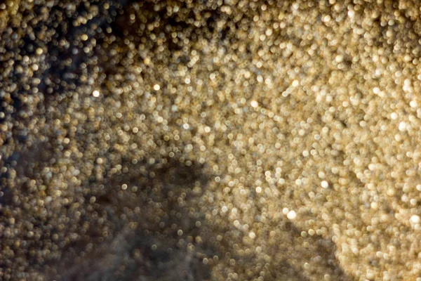 Gold dust dekoráció blured fekete háttér — Stock Fotó