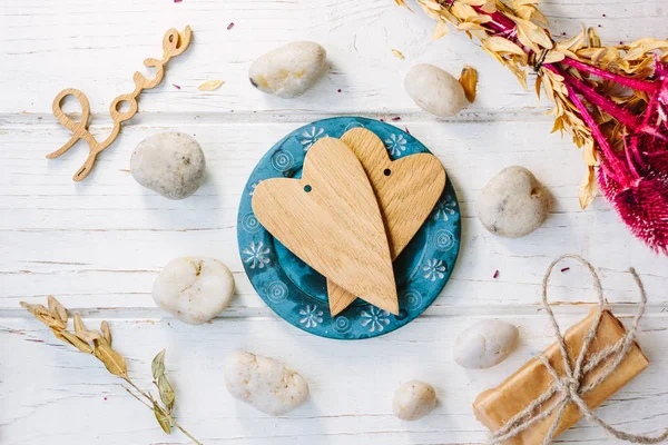 Two wooden hearts on blue plate - Valentine 's day concept — стоковое фото