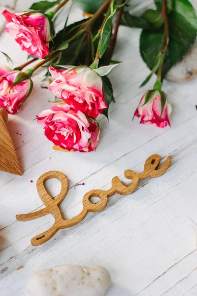 Trä ordet kärlek med rosor och hjärtan - alla hjärtans dag bakgrund — Stockfoto