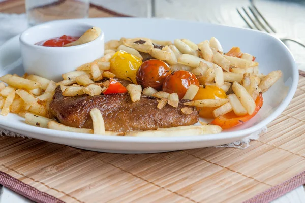 Vegetarisches Steak aus veganem Seitan, Kirschtomaten und Pommes — Stockfoto