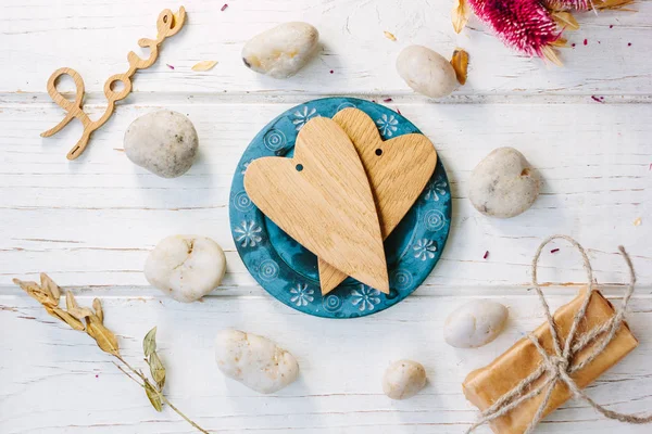 Two wooden hearts on blue plate - Valentine 's day concept — стоковое фото