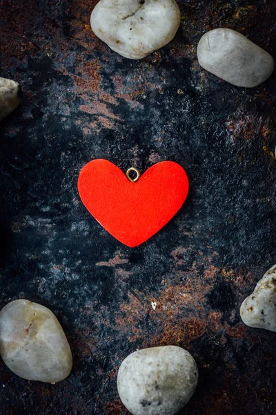 Red heart in circle of rocks