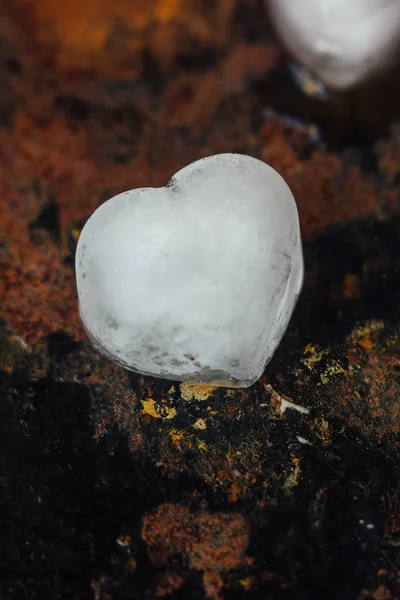 Ice in form of hearts on black background starting to melt. — Stock Photo, Image