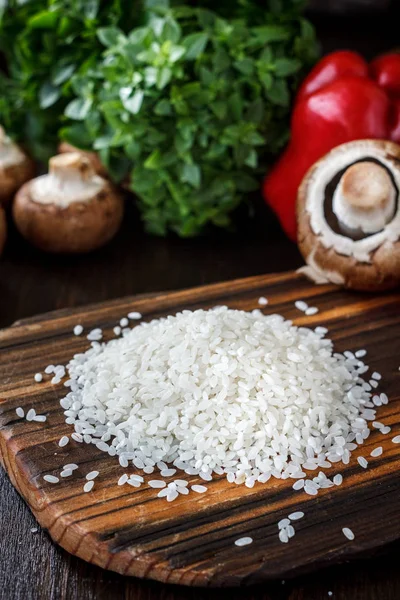 Tablero de madera con verduras y arroz . — Foto de Stock