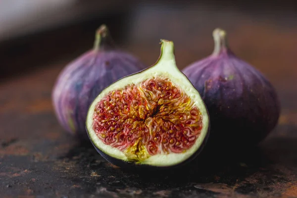 Beautiful and fresh figs on rusty surface. Half of fig. — Stock Photo, Image