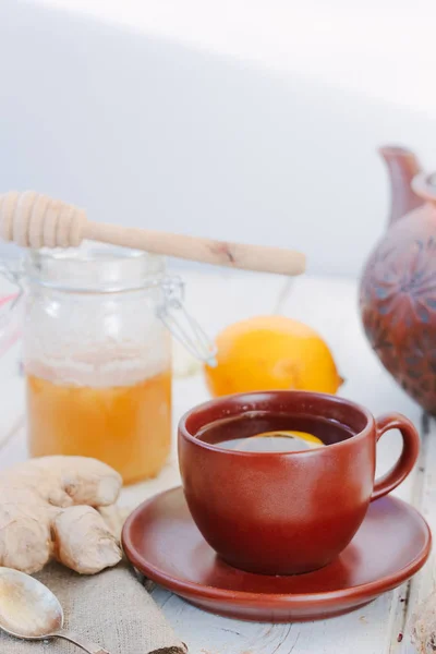 Nice ginger tea on white wooden surface. — Stock Photo, Image