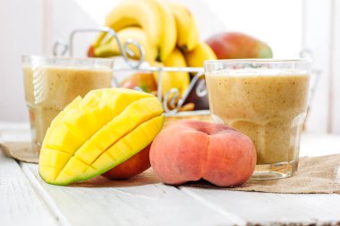 Mango ve şeftali smoothie malzemeler ahşap tablo.