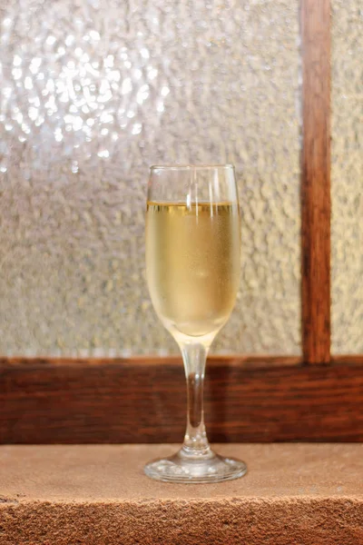 Glass filled by fresh champagne on restaurant.