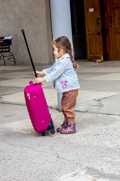 Little girl travel alone. Now she on the railway station