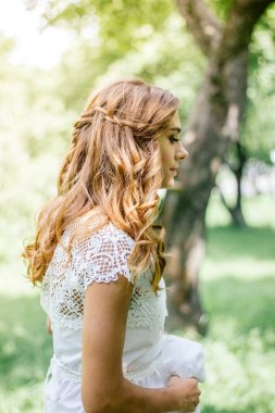 Açık havada güzel yeşil orman üzerinde gelin saç modeli.