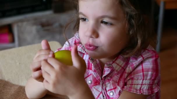 Footage Adorable Little Girl Eating Ripe Apple Home — Stock Video