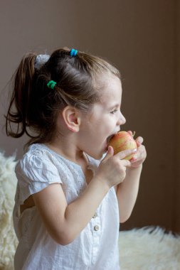 Komik küçük kız elma yiyor..