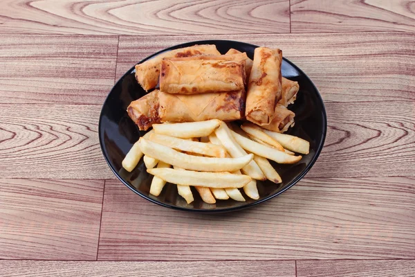 Chinese Vegetable festival  food as deep fried spring roll and French fries served.