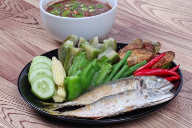 Yakın kadar hazır garnitür hizmet için derin ateş gibi mackarels, uzun-patlıcan haşlanmış, mercimek, kanatlı fasulye, kırmızı sıcak biber biber daldırma Tay baharatlı ekşi ve dilimlenmiş salatalık ahşap üzerine. Seçici odak.