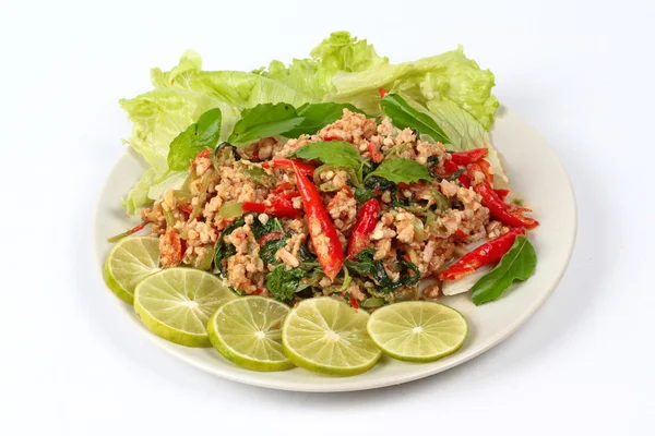 Fried spicy basil with minced pork topped sliced green lemon and and lettuce is top ten of popular Thai food. — Stock Photo, Image