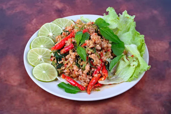 Thai food,Fried spicy basil with minced pork topped sliced green lemon and and lettuce . — Stock Photo, Image