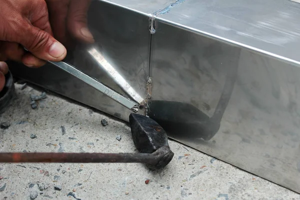 Aluminium gutter welding by using soldering copper with picnic gas:Technician is welding aluminium pipe by using soldering copper.