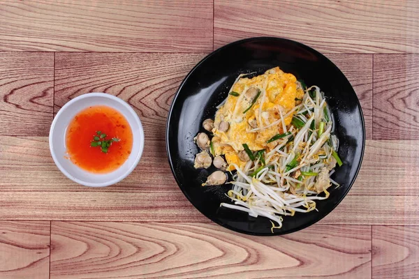Comida tailandesa, huevo frito y ostra con brotes de frijol y chalota como Hoi Tod Khai en tailandés servido con salsa de chile . — Foto de Stock